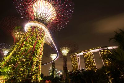 Low angle view of illuminated ferris wheel at night