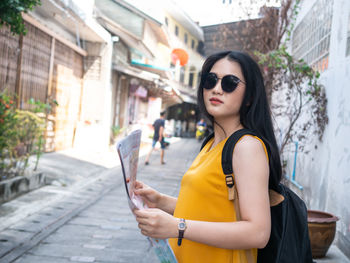 Young woman using mobile phone in city