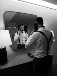 Reflection of man talking on telephone in mirror