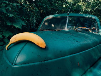 Close-up of banana on old car