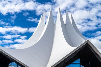 Low angle view of building against cloudy sky