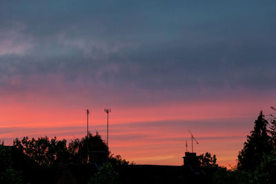 Silhouette trees against sky at sunset