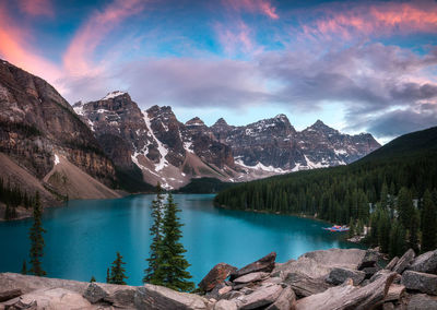 Scenic view of lake by mountains against sky