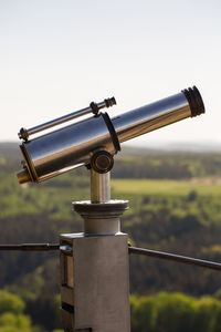 Close-up of coin-operated binoculars against clear sky