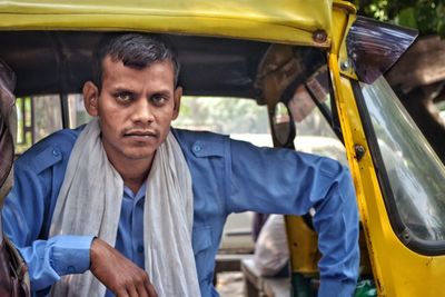 Portrait of man sitting in auto rickshaw