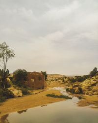 Scenic view of lake amidst buildings against sky