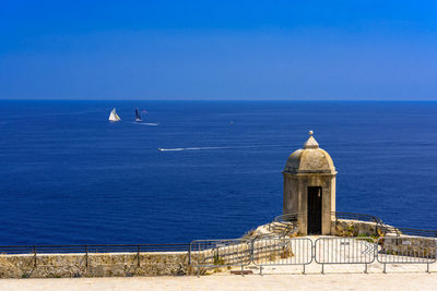 Scenic view of sea against clear blue sky