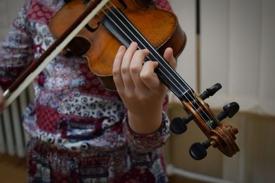 Midsection of woman playing violin