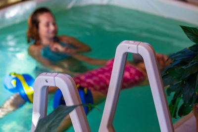 Woman relaxing in swimming pool