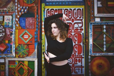 Young woman dancing standing against door