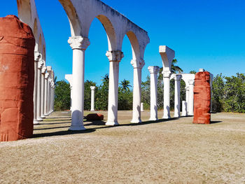 Columns of historical building against blue sky