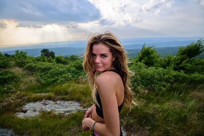 Beautiful young woman against sea against sky