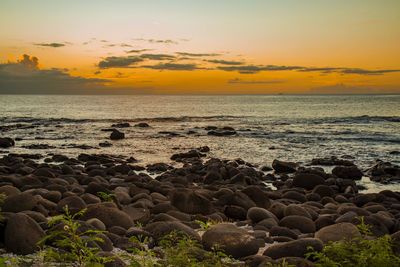 Sunset on the rocky beach of albion, mauritius.