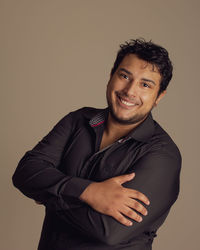 Portrait of young man against gray background