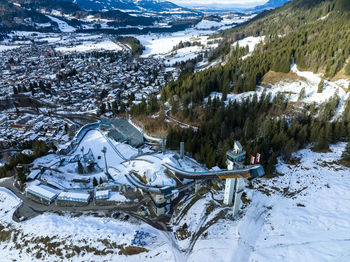 Germany, bavaria, oberstdorf, aerial view of ski resort and surrounding town in winter