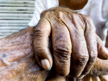 Midsection of senior men holding hands