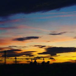 Silhouette of buildings against cloudy sky