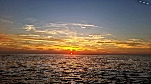 Scenic view of sea against romantic sky at sunset