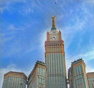 Low angle view of buildings against cloudy sky