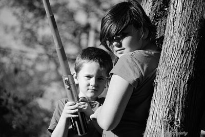 Portrait of siblings with boy holding fishing rod