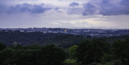 High angle view of cityscape against cloudy sky