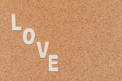 Close-up of love text on brown table
