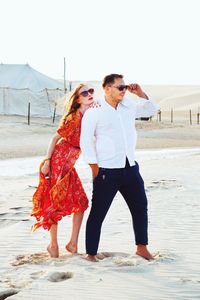 Full length of young woman standing on beach