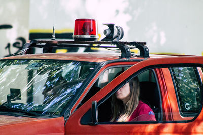 Portrait of woman sitting by car window