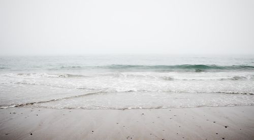Scenic view of beach against clear sky