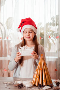 Christmas handmade. a girl holding an eco gift furoshiki in her hands. zero waste