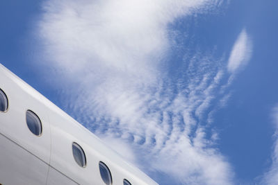 Airplane fuselage mid plane with blue skies