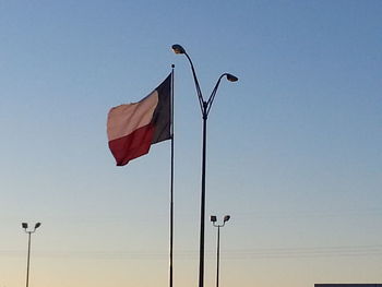 Low angle view of flag against clear sky