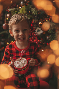 Portrait of cute girl playing christmas tree