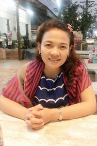 Portrait of smiling woman sitting at restaurant