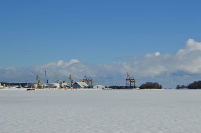 Scenic view of beach against blue sky