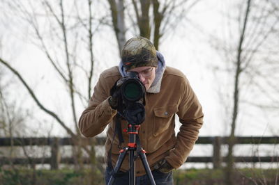 Man photographing with umbrella