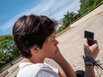 Portrait of boy photographing with mobile phone