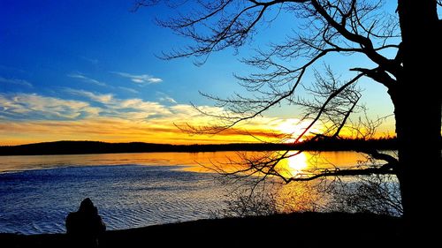 Scenic view of lake against sky during sunset