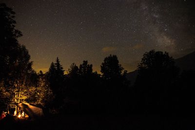 Silhouette trees against sky at night