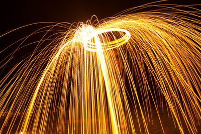 Man making wire wool at night