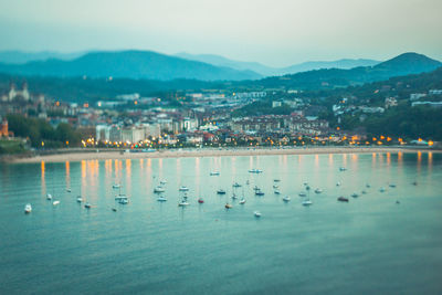 Scenic view of sea by city against sky