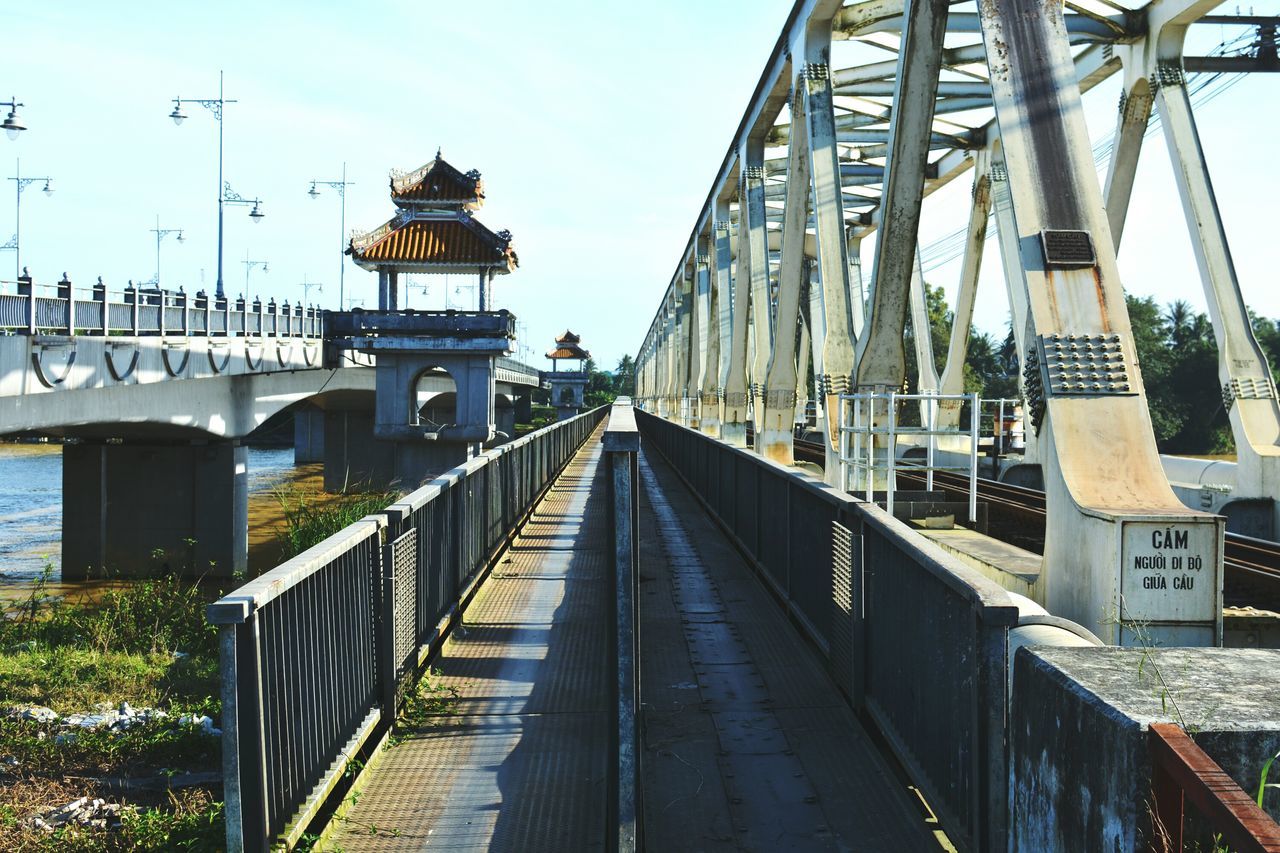 built structure, bridge - man made structure, architecture, railing, day, connection, outdoors, the way forward, sky, travel destinations, water, building exterior, transportation, no people, nature