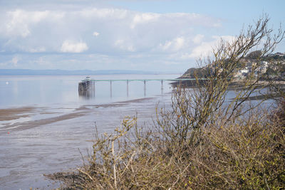 Panoramic photo of clevedon pier in somerset showing iron structure against blue sky