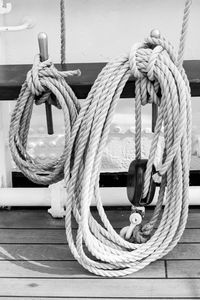 Ropes tied to metals on railing in boat