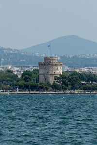 Scenic view of sea and buildings against sky