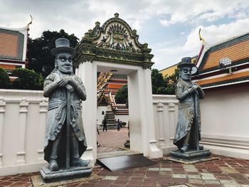 Statue outside building against sky