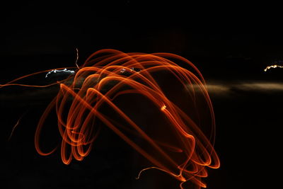 Light trails against black background