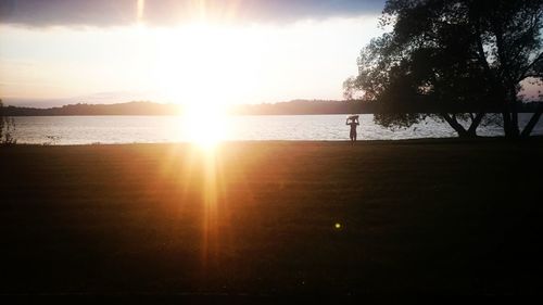 Scenic view of lake against sky during sunset