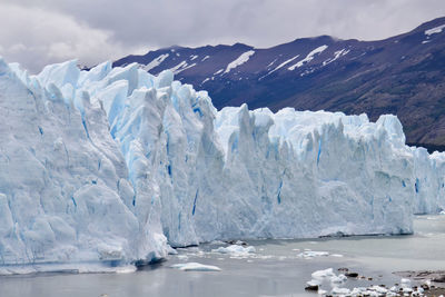 Scenic view of sea and glacier against sky