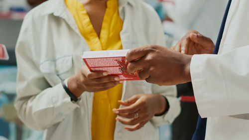 Midsection of doctor examining patient in laboratory